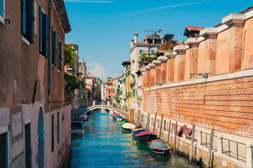 Traditional canal street with boats in Venice, Italy.