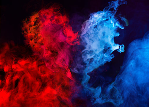 Abstract Shapes Of Red And Blue Smoke In Heart Shape At Dark Background