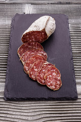 Saucisson sec delicious french salami on a wooden background