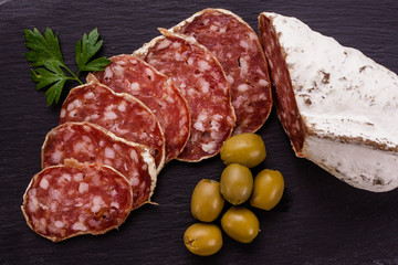 Saucisson sec delicious french salami on a wooden background