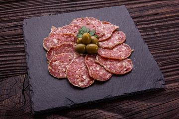 Saucisson sec delicious french salami on a wooden background
