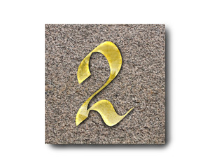 Gold number of the English alphabet on a granite plate