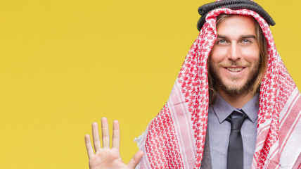 Young handsome arabian man with long hair wearing keffiyeh over isolated background showing and...