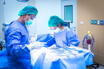 Team surgeon at work in operating room.