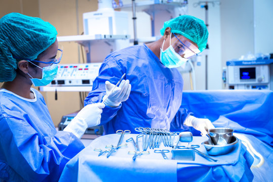 Team of surgeon in uniform perform operation on a patient at cardiac surgery clinic.