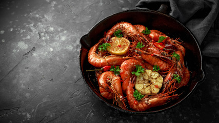 Tiger prawns fried in butter with, lemon juice, garlic and white wine served in cast iron skillet with parsley