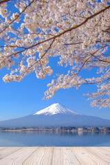 Empty wood table with Fuji mountain and pink cherry blossom flower background, Mock up for your product display or montage
