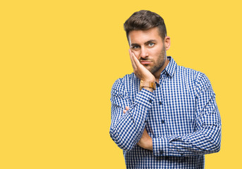 Young handsome man over isolated background thinking looking tired and bored with depression...