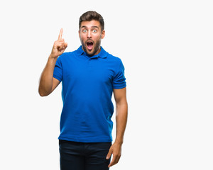 Young handsome man over isolated background pointing finger up with successful idea. Exited and happy. Number one.