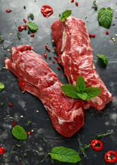 Raw lamb shoulder fillets with chilli, thyme and mint leaves