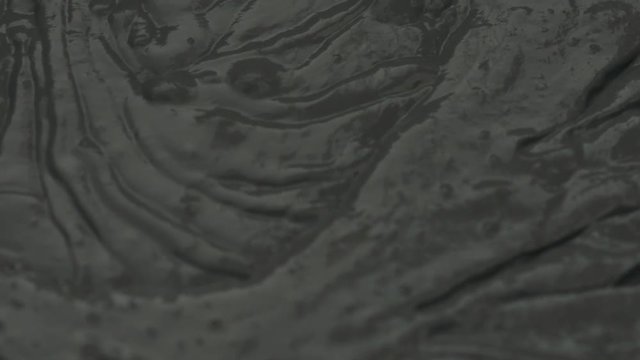 Slow motion closeup mixing dark gray micro concrete plaster