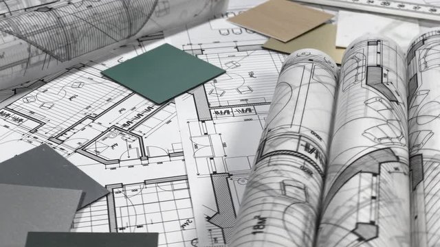 Blueprints: architectural drawings, yardstick - folding ruler & samples of modern interior decoration materials - decorative plastics smoothly rotate on the surface of the architectural plan