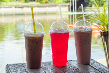 Cold drink on a wooden table by the river.