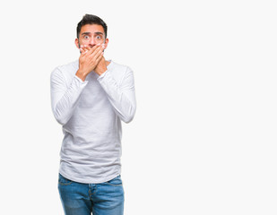 Adult hispanic man over isolated background shocked covering mouth with hands for mistake. Secret concept.