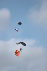 paragliders with the flags in the sky