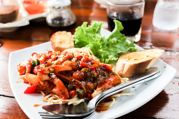 Close up of Spaghetti with tomato sauce and Garlic bread