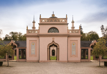 Fototapeta na wymiar Schwetzinger castle garden. Entrance to the red mosque in the Turkish garden. Schwetzingen, Baden-Wuerttemberg, Germany, Europe