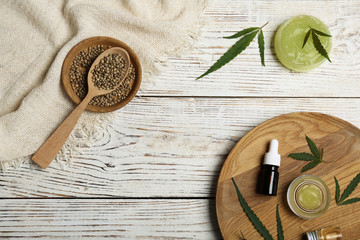 Flat lay composition with hemp lotion on wooden background