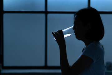 Asian women drink water after waking up in the morning.