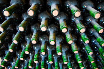 Stacked up dusty wine bottles in a wine cellar