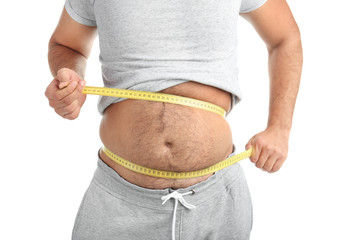 Overweight man with measuring tape on white background, closeup