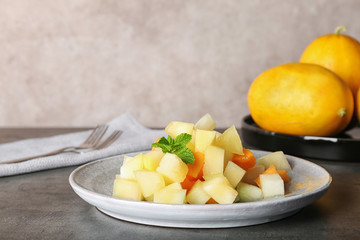 Plate of salad with assorted melons on table