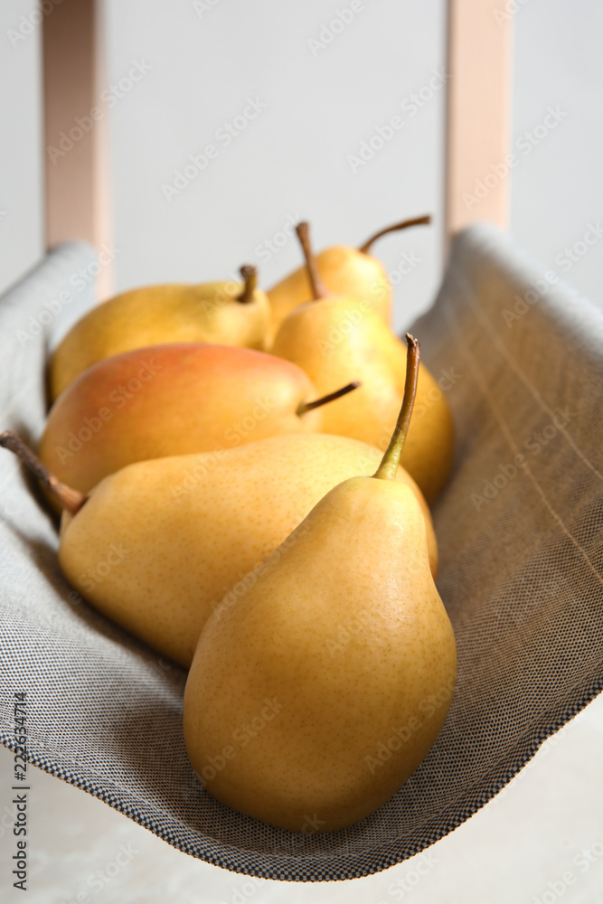 Wall mural ripe yellow pears on fabric shelf, closeup