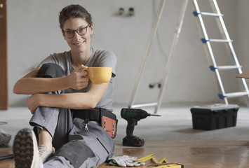 Woman doing a home renovation and having a coffee break