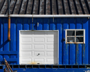 Colorful and rustic royal blue shed in St. Anthony, Newfoundland