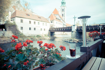 autumn terrace. Wine in a glass. Blooming balcony overlooking the river. The season of autumn and hot wine. Mulled wine for relaxation