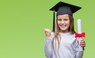 Young beautiful girl wearing graduate cap holding degree over isolated background screaming proud and celebrating victory and success very excited, cheering emotion