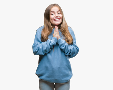 Young beautiful girl wearing winter sweater over isolated background praying with hands together asking for forgiveness smiling confident.