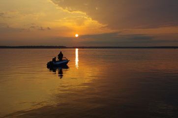 Naklejka na ściany i meble Fishing boat on sunset