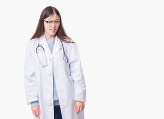 Young Chinese doctor woman over isolated background winking looking at the camera with sexy...