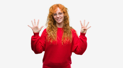 Obraz na płótnie Canvas Young redhead woman wearing red sweater showing and pointing up with fingers number nine while smiling confident and happy.