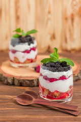 Trifle close up photography with fresh multi layered dessert with dairy and ripe raspberries and...