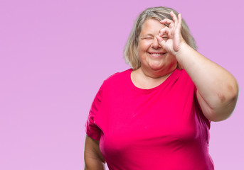 Senior plus size caucasian woman over isolated background smiling and looking at the camera pointing with two hands and fingers to the side.