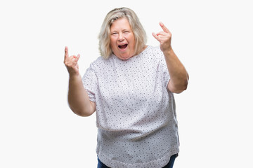 Fototapeta na wymiar Senior plus size caucasian woman over isolated background smiling and looking at the camera pointing with two hands and fingers to the side.
