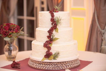 Obraz na płótnie Canvas Three Tier Wedding Cake With Roses Strip Decor