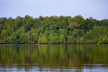Fototapeta na wymiar Autumn Trees Reflecting Over Lake