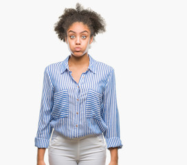 Young afro american woman over isolated background puffing cheeks with funny face. Mouth inflated with air, crazy expression.