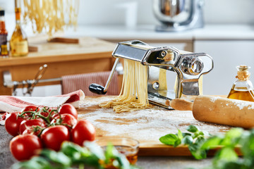 Noodle maker sitting on board in front of kitchen