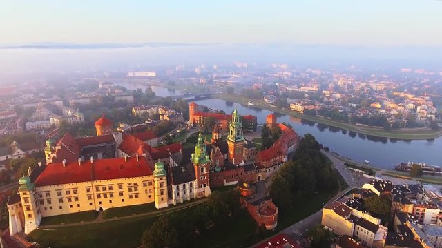 Krakow, Poland. Wawel royal Castle and Cathedral, Vistula River. Aerial 4K flyby video at sunrise in summer