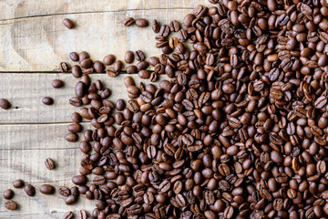 Fresh roasted coffee beans on rustic wood background