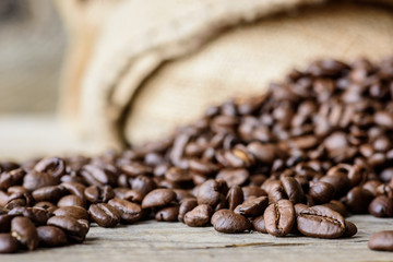 Fresh roasted coffee beans on rustic wood background