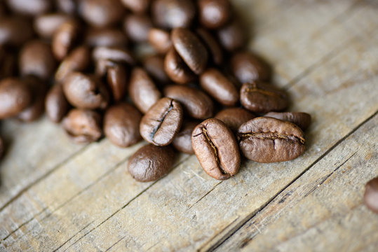 Fresh roasted coffee beans on rustic wood background