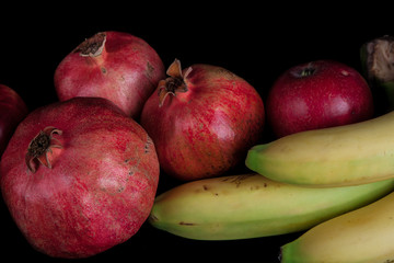 pomegranates on a black background