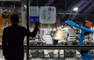 Engineer touch screen control the production of factory parts manufacturing industry robots and mechanical arm