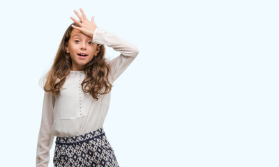 Brunette hispanic girl surprised with hand on head for mistake, remember error. Forgot, bad memory...