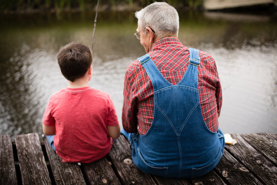 Happy Great Grandfather And Grandson Fishing Together